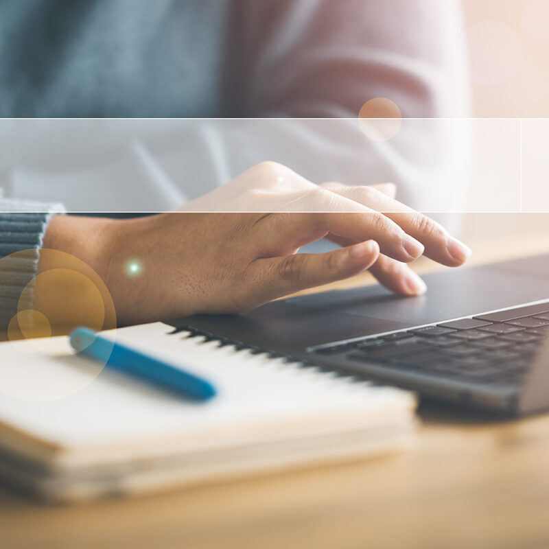 Person using a laptop with search bar overlay, symbolizing digital search and SEO strategy